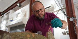 Conservator, Kris Zykubek at work on the terracotta pot from Sissinghurst Gardens
