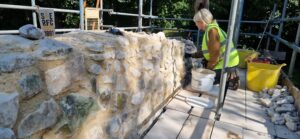 Lauren using hot mixed lime mortar to consolidate the chalk ruins at Ankerwycke Priory.