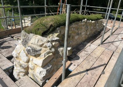 The decision was taken to soft cap the highest sections of the ruin using turf and sedum plugs.