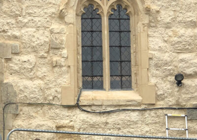 Renewed hood mould and shelter coating to tracery window.