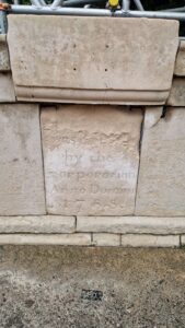 Stonework with weathered lettering