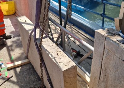 Stone being lifted using straps