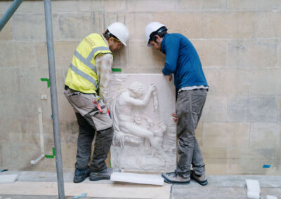 Lifting a plaster relief.