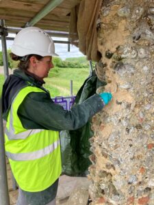 Conservator carrying out lime mortar repairs