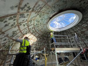 Conservators working on a painted ceiling