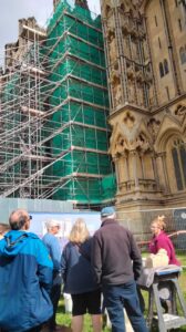 Conservator talking to visitors to Wells Cathedral