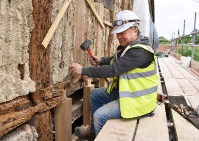 Cliveden Conservation craftsman using hand tools to carry out structural timber frame repairs at Walpole Old Chapel.