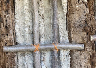 New wattles replacing rotted poles in original 17th century daub channels.