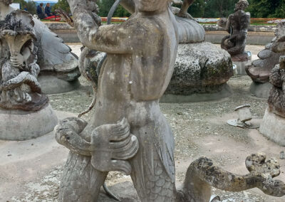 Close-up of a marble figure from the South Fountain at Waddesdon Manor before conservation, showing structural deterioration and damage to the outermost parts of the sculpture.