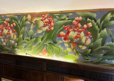 view of a section of the conserved floral frieze in the reception room at Plumpton House, showing the stabilised and retouched paintwork.