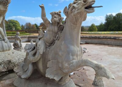 The marble sculpture of an infant triton riding a hippocampus at the South Fountain, Waddesdon Manor, following conservation treatment by Cliveden Conservation.